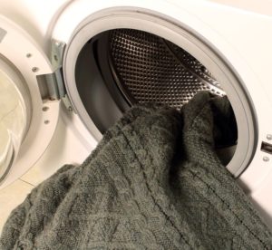 Πλύσιμο ενός ακρυλικού πουλόβερ σε ένα πλυντήριο