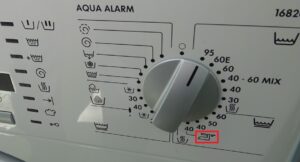 Wat betekent het ijzeren bordje op een wasmachine?