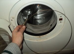 How to put a spring on a washing machine drum?